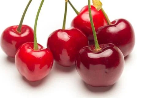 Small red cherries on a white background Stock Photos