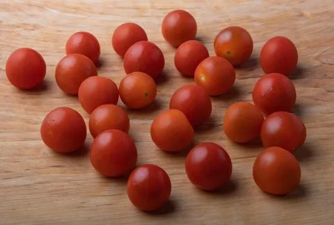 Small red cherry tomatoes, just washed, with water droplets, on a natural w.. Stock Photos