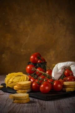 Small red cherry tomatoes on several twigs with bruschetta Stock Photos