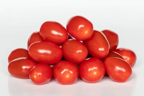 Small red cherry tomatoes on white background Stock Photos