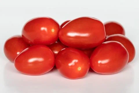 Small red cherry tomatoes on white background, close up Stock Photos