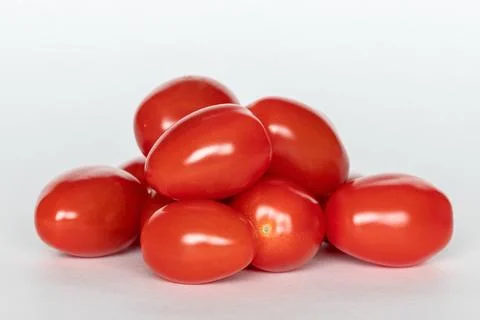 Small red cherry tomatoes on white background Stock Photos
