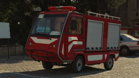 Small red fire truck parked on a cobblestone street in Baku old city Stock-Footage 344901269