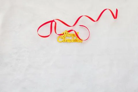 Small red gift box and gold merry christmas text with red ribbon Stock Photos