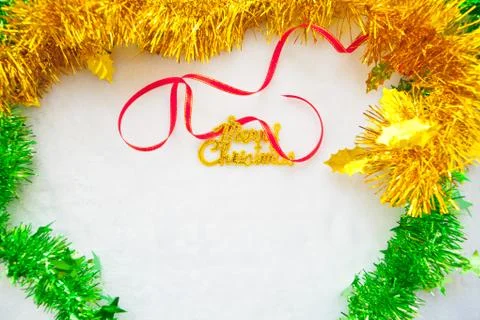 Small red gift box and gold merry christmas text with red ribbon Stock Photos