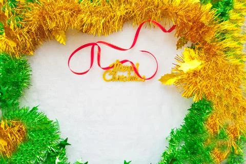 Small red gift box and gold merry christmas text with red ribbon Stock Photos