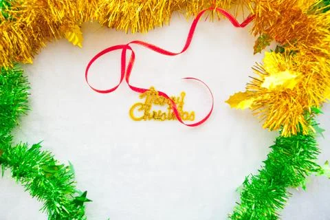 Small red gift box and gold merry christmas text with red ribbon Stock Photos