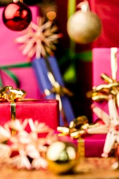 Small red gift box under baubles. Stock Photos