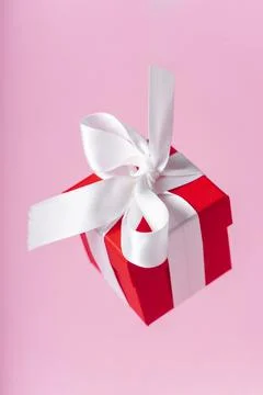 Small red gift box with white ribbon Stock Photos