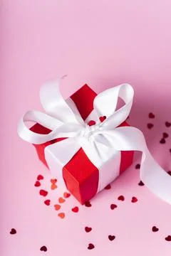 Small red gift box with white ribbon Stock Photos