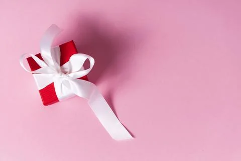 Small red gift box with white ribbon Stock Photos