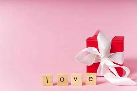 Small red gift box with white ribbon Stock Photos