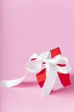 Small red gift box with white ribbon Stock Photos