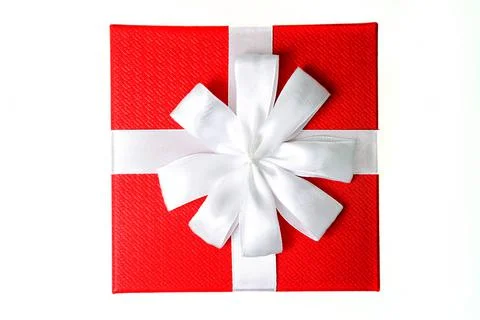 Small red gift box with a white bow on a white background. Stock Photos