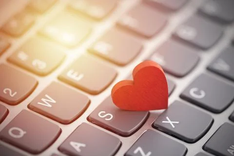 Small red heart on computer keyboard. Internet dating concept. Stock-Fotos