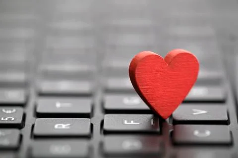 Small red heart on keyboard. Internet dating concept. Stock-Fotos