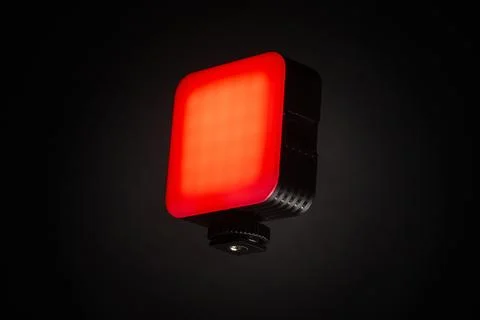 Small red LED light panel isolated on dark background for creative lighting Foto stock