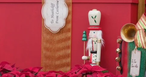 Small Red Nutcracker Standing Among Presents in Christmas / Holiday Display Vidéo 99460374
