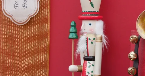 Small Red Nutcracker Standing Among Presents in Christmas / Holiday Display Vidéo 99460434