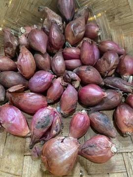 Small red onion inside the bamboo basket Stock Photos