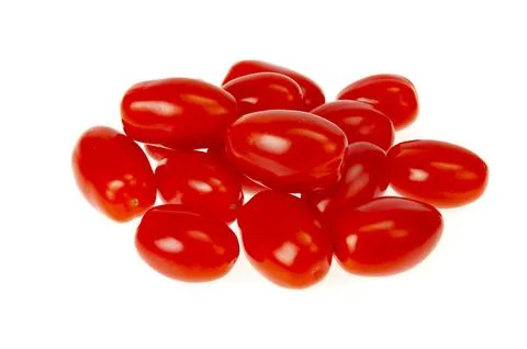Small red oval cocktail cherry tomatoes on white background. Studio Photo Stock Photos