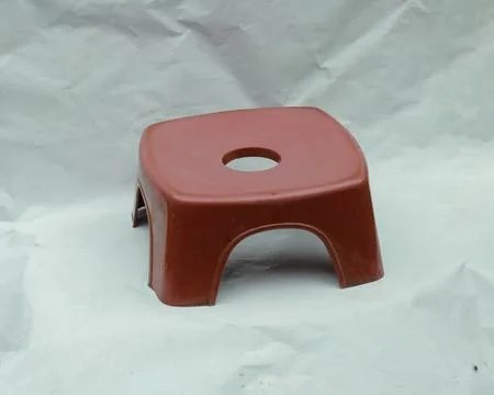 A small red plastic chair Stock Photos