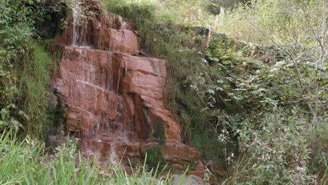 Small red rock waterfall Stock Footage 140442828
