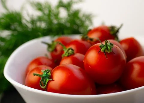 Small red tomatoes and dill Stock Photos