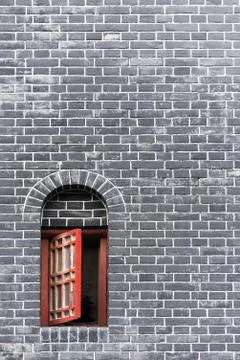 Small red window in a brick wall 스톡 사진