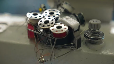 Small reels with colourful threads and fabric straight pins on the top of sewing Stock Footage 252427741