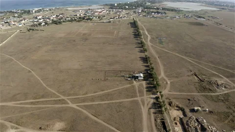 Small residential area surrounded by fields and sea Stock Footage 145332251