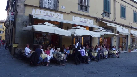 Small restaurants and bars in the narrow streets of Lucca Stock Footage