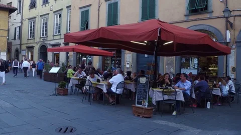 Small restaurants and bars in the narrow streets of Lucca Stock Footage