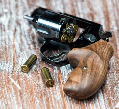 Small revolver lying on a  table Stock Photos