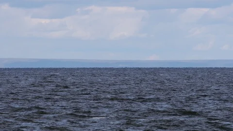 Small ripples and waves on the surface of the water of the reservoir river Stock Footage 119165622
