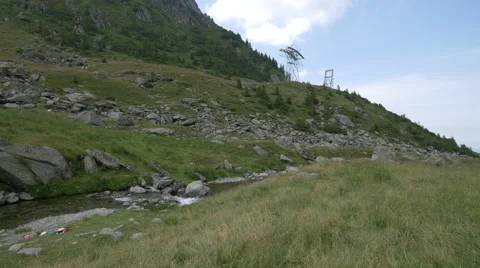 Small river and electric power towers in Transfagarasan Stock Footage 55380732
