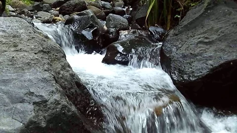 Small river and waterfall stream on kali pjok on rahtawu, indonesia Video stock 124728968