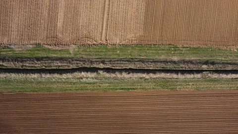 A small river between plowed fields top view Stock Footage 201373678