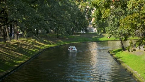 Small river channel ferry transporting tourists in Riga city center in a sunny 動画素材 110806794