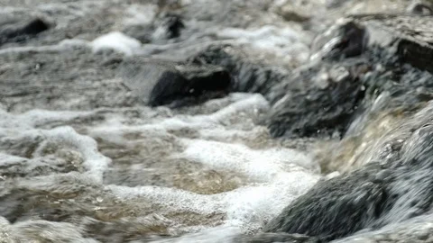 Small river close-up. Powerful water stream among boulders in mountain creek Stock Footage 125443361