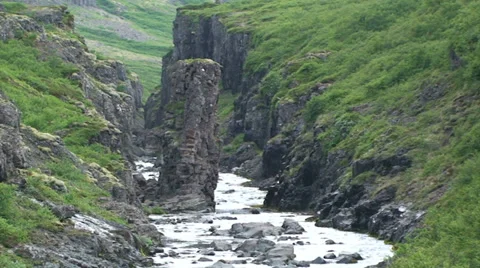Small river cuts through volcanic rock Stock Footage 37299907