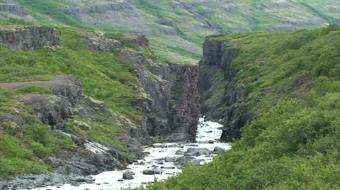 Small river cuts through volcanic rock Stock Footage 37301675