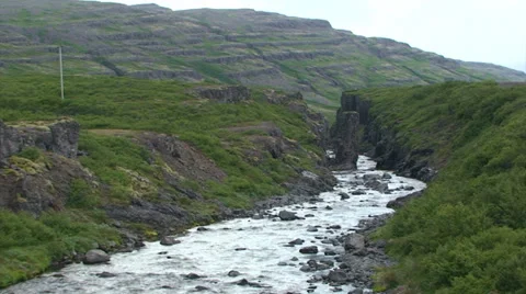 Small river cuts through volcanic rock Stock Footage 37302275