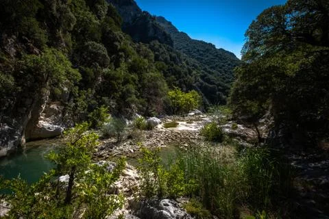 Small river enveloped with rocks. Closeup of river scenes in forest in Epirus Stock Photos