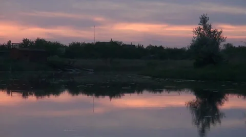 The small river is in evening time on a background a village Stockbeeldmateriaal 33702344