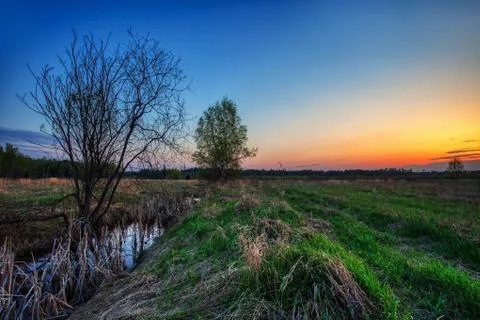 Small river in field Stock Photos
