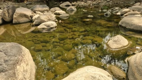 A small river flowing in the rocky mountains during the dry season Stock Footage 321283331