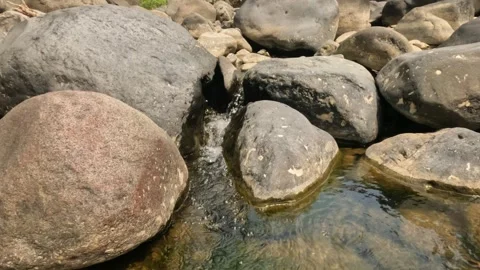 A small river flowing in the rocky mountains during the dry season Stock Footage 321283379