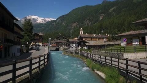 Small river flowing in a typical mountain village in the Italian Alps Stock Footage 112006787