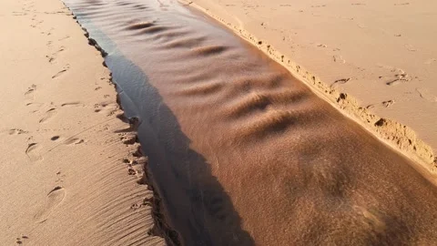 Small river flows along the beach Stock Footage 143732890